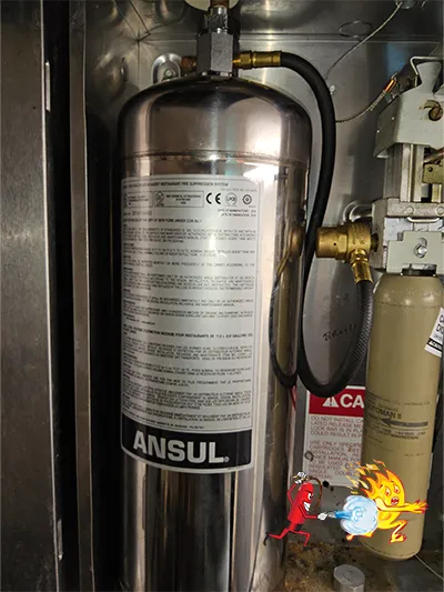 Kitchen fire suppression control panel mounted near cooking equipment